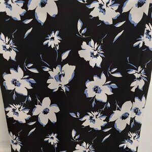 Wide leg dark blue pants with white floral pattern.